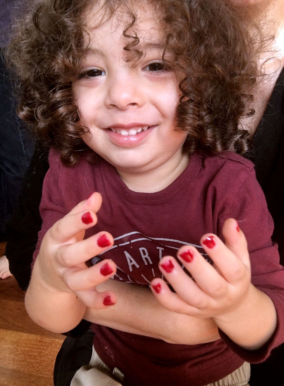 kid licks edible nail polish